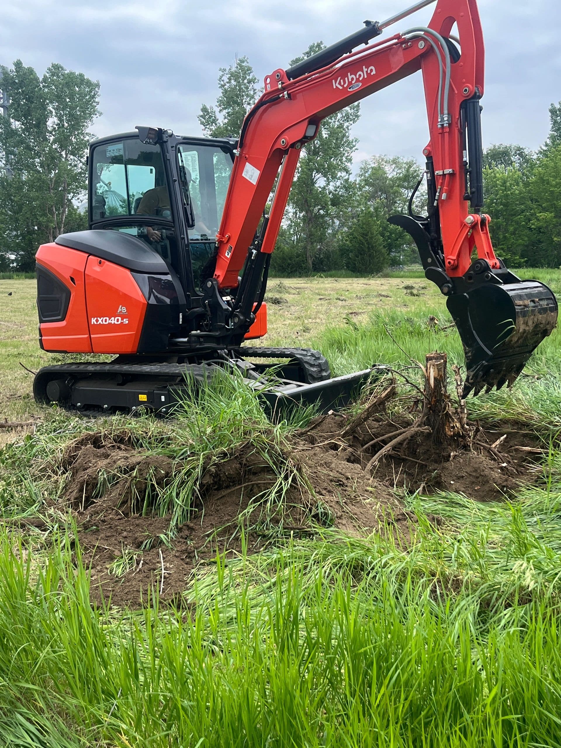 Kubota KX040-5 mini excavator working on a job